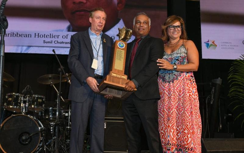 Sunil Chatrani Named 2019 Hotelier Of The Year - Hotelier Sunil Chatrani (center) receives his award from CHTA's Director General Frank Comito (left) and CHTA President Patricia Affonso-Dass.